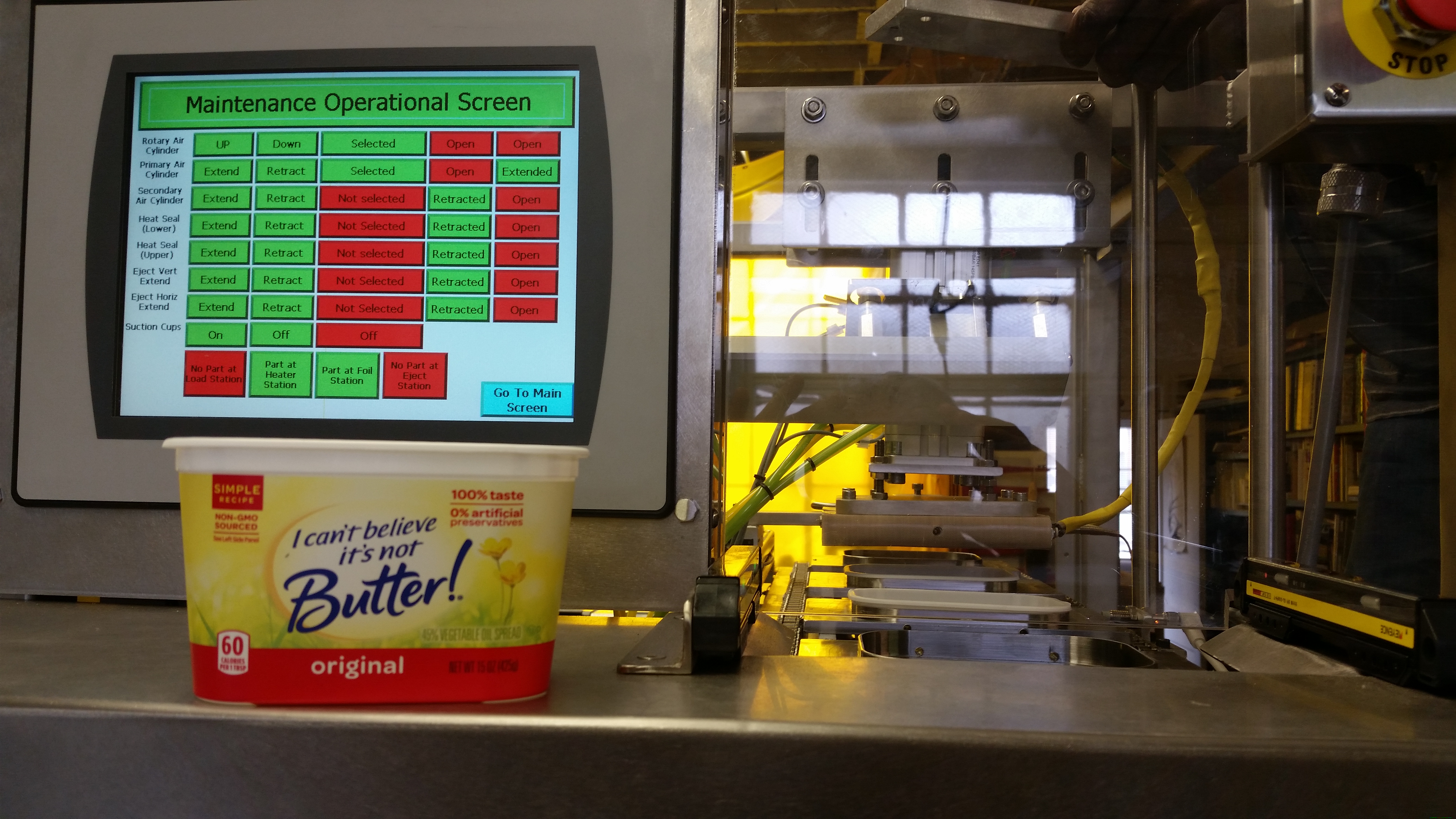 Tub sealer production machine with maintenance screen and sealed product container in view